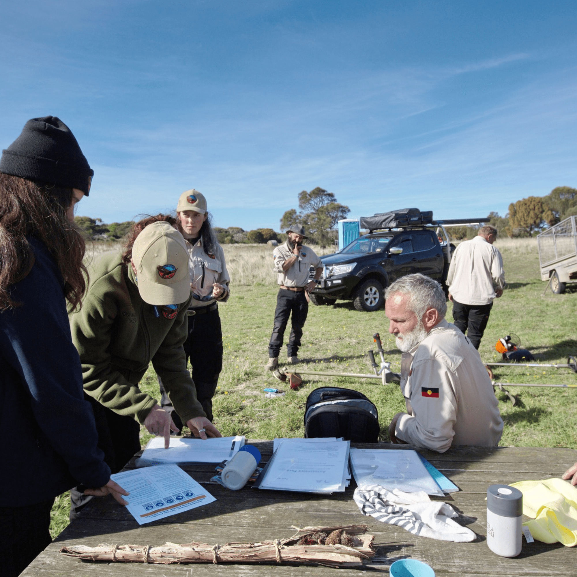 Aboriginal ranger with fire hose conducting cultural burning for land management